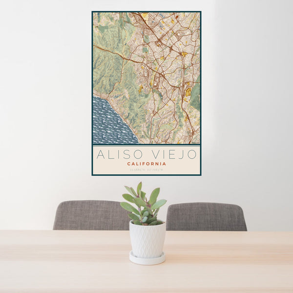 24x36 Aliso Viejo California Map Print Portrait Orientation in Woodblock Style Behind 2 Chairs Table and Potted Plant