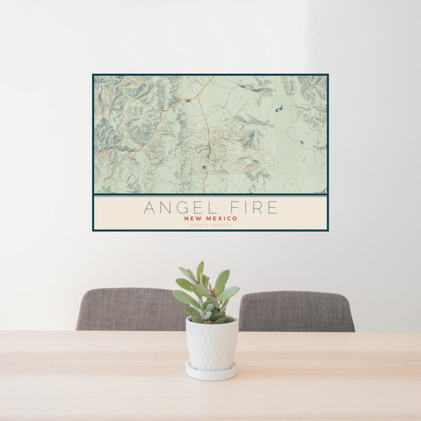 24x36 Angel Fire New Mexico Map Print Landscape Orientation in Woodblock Style Behind 2 Chairs Table and Potted Plant