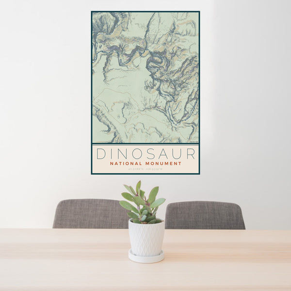 24x36 Dinosaur National Monument Map Print Portrait Orientation in Woodblock Style Behind 2 Chairs Table and Potted Plant