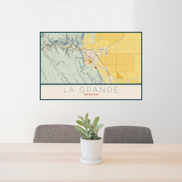 24x36 La Grande Oregon Map Print Landscape Orientation in Woodblock Style Behind 2 Chairs Table and Potted Plant