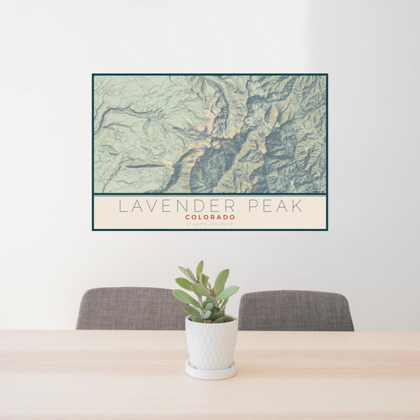 24x36 Lavender Peak Colorado Map Print Lanscape Orientation in Woodblock Style Behind 2 Chairs Table and Potted Plant