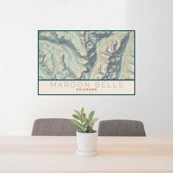 24x36 Maroon Bells Colorado Map Print Lanscape Orientation in Woodblock Style Behind 2 Chairs Table and Potted Plant