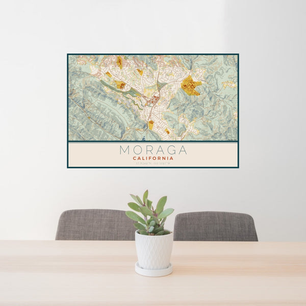24x36 Moraga California Map Print Lanscape Orientation in Woodblock Style Behind 2 Chairs Table and Potted Plant