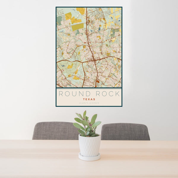 24x36 Round Rock Texas Map Print Portrait Orientation in Woodblock Style Behind 2 Chairs Table and Potted Plant