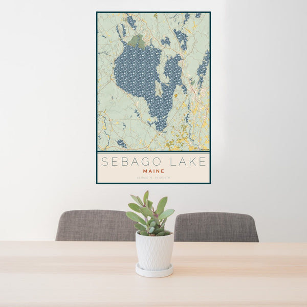 24x36 Sebago Lake Maine Map Print Portrait Orientation in Woodblock Style Behind 2 Chairs Table and Potted Plant