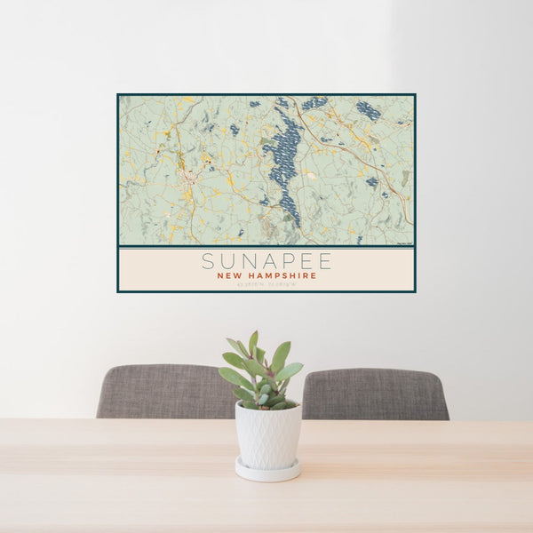 24x36 Sunapee New Hampshire Map Print Lanscape Orientation in Woodblock Style Behind 2 Chairs Table and Potted Plant