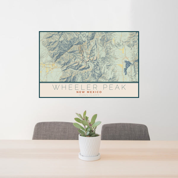 24x36 Wheeler Peak New Mexico Map Print Lanscape Orientation in Woodblock Style Behind 2 Chairs Table and Potted Plant